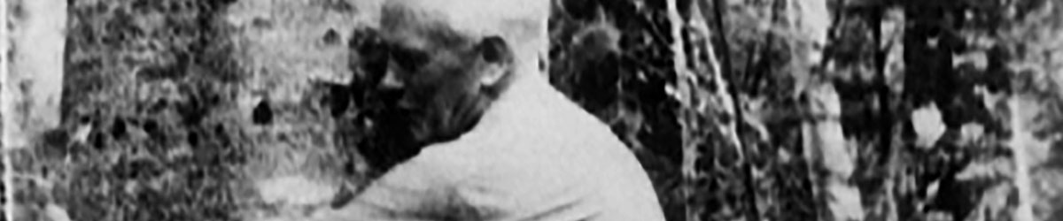 An old man hugging a tree.