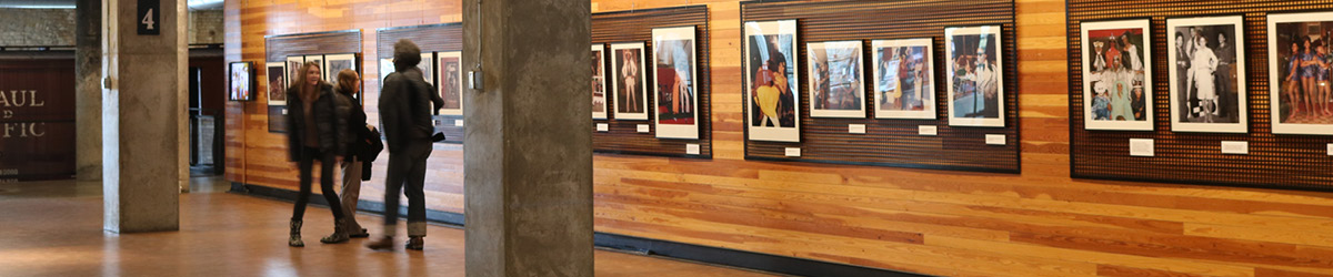 People viewing photos on a wall at Mill City Museum.