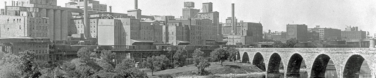 Historic photo of the stone arch bridge and view of the Minneapolis riverfront.