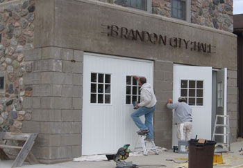 Photo: Workers restoring Brandon Auditorium doors