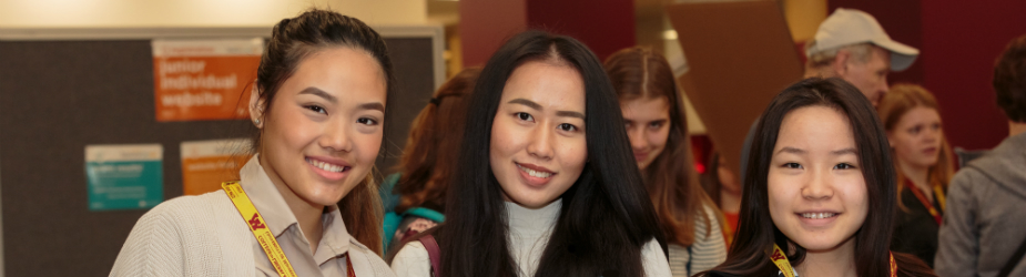 Three students smiling.