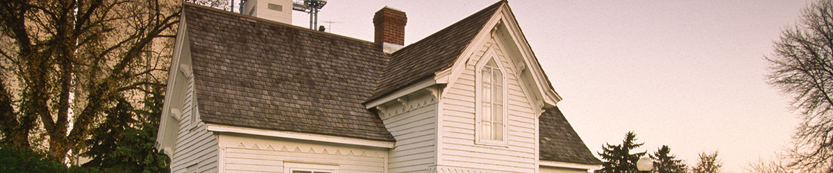 W. W. Mayo House in front of a tree without leaves.